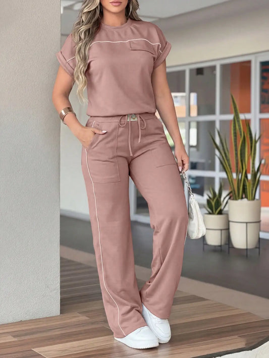 New Spring‑Autumn Women’s Color‑Contrast Stitching Two‑Piece Outfit. Crew‑neck short‑sleeve top with decorative pockets, drawstring high‑waist wide‑leg trousers with side practical pockets. Made of stretchy &
