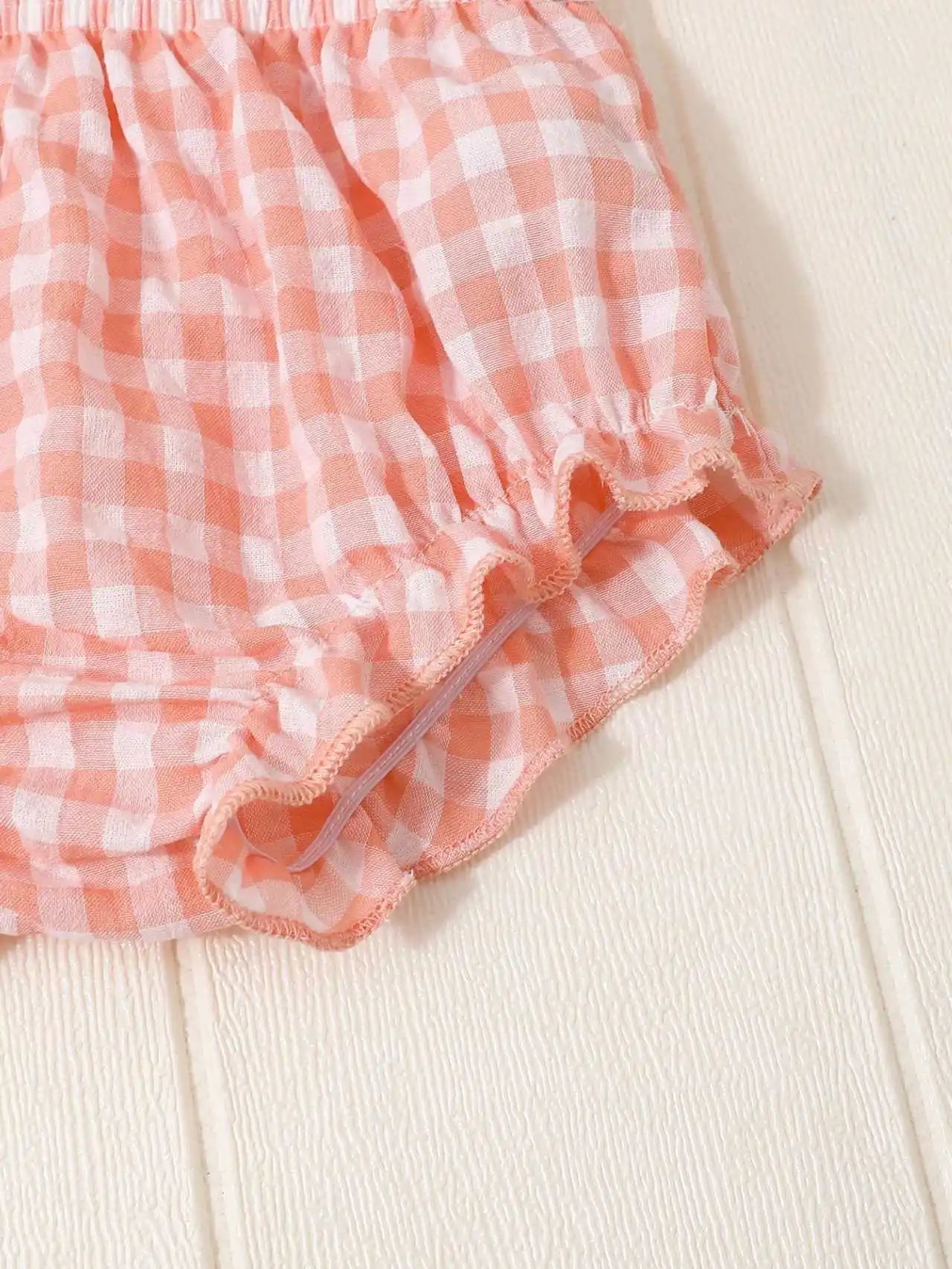 Newborn baby girl two-piece set: white cotton pleated sleeveless checkered top and matching triangular leggings