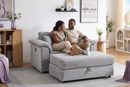 An adult couple sharing the corduroy armchair with its matching storage ottoman in a styled living room