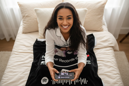 Woman Pointing Phone Directly Down on Spotify Blanket